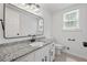 Beautiful bathroom features granite countertops, white cabinets, a black framed mirror, and black hardware at 3717 Birchbriar Ct, Decatur, GA 30034