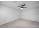 This bedroom is carpeted, painted white, and has a fan and closet at 3717 Birchbriar Ct, Decatur, GA 30034