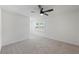 Neutral carpet in an airy room with a ceiling fan and window at 3717 Birchbriar Ct, Decatur, GA 30034