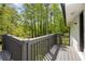 View of a deck overlooking a private backyard with natural views and a painted gray wooden railing at 3717 Birchbriar Ct, Decatur, GA 30034