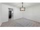 Bright dining room with fresh paint and new gray carpet offers a modern chandelier at 3717 Birchbriar Ct, Decatur, GA 30034