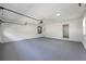 Clean two-car garage with epoxy floor, white walls, overhead lights, and door to the house at 3717 Birchbriar Ct, Decatur, GA 30034