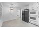 Bright kitchen features white cabinets, stainless steel appliances, and adjacent dining space at 3717 Birchbriar Ct, Decatur, GA 30034