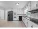 Modern kitchen boasts stainless steel appliances, granite counters, and white subway tile backsplash at 3717 Birchbriar Ct, Decatur, GA 30034