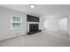 Spacious living room includes a brick fireplace with a painted white mantle and a door to the deck at 3717 Birchbriar Ct, Decatur, GA 30034