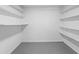 Walk-in pantry with white walls, shelves, and a light gray epoxy floor at 3717 Birchbriar Ct, Decatur, GA 30034