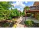 Beautiful backyard with a deck, patio seating, mature trees, and well-manicured landscaping at 4231 Shamans Dr, Marietta, GA 30062