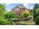 Picturesque backyard with lush landscaping, patio, and a charming brick exterior at 4231 Shamans Dr, Marietta, GA 30062