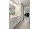 Bright bathroom with double sinks, white cabinets, and tile flooring, leading to an adjacent room at 4231 Shamans Dr, Marietta, GA 30062