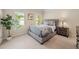 Comfortable bedroom featuring a plush queen bed, soft carpet, and natural light from the windows at 4231 Shamans Dr, Marietta, GA 30062