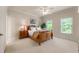 Inviting bedroom with a wooden bed frame, soft carpet, and sunlit windows providing a cozy ambiance at 4231 Shamans Dr, Marietta, GA 30062
