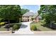 Traditional two-story brick and siding home with a well-manicured lawn and symmetrical landscaping at 4231 Shamans Dr, Marietta, GA 30062