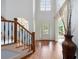 Grand foyer with soaring ceilings, hardwood floors, and a staircase with iron railings at 4231 Shamans Dr, Marietta, GA 30062