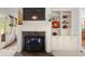 Cozy living room featuring a fireplace with marble surround and built-in shelving at 4231 Shamans Dr, Marietta, GA 30062