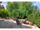 Seating area on a stone patio with a fire pit and manicured landscaping creates a peaceful backyard retreat at 4231 Shamans Dr, Marietta, GA 30062