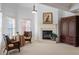 Cozy seating area features a fireplace, arm chairs, side table, and natural light from the window at 4231 Shamans Dr, Marietta, GA 30062