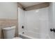Clean bathroom with tiled walls, a sleek white bathtub and modern black hardware at 122 Maison Nw Pl, Atlanta, GA 30327