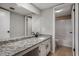Bathroom with granite countertops, a large mirror and a door to the toilet and bathtub at 122 Maison Nw Pl, Atlanta, GA 30327
