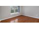Bright bedroom with hardwood floors and a large window offering natural light at 122 Maison Nw Pl, Atlanta, GA 30327