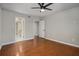 Large bedroom featuring wood floors, neutral walls, and convenient access to a private bath at 122 Maison Nw Pl, Atlanta, GA 30327