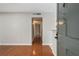 Hallway with hardwood floors, light gray walls and access to other rooms at 122 Maison Nw Pl, Atlanta, GA 30327