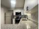 Modern kitchen features stainless appliances, granite countertops, and white cabinetry at 122 Maison Nw Pl, Atlanta, GA 30327