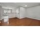 Open concept living area featuring hardwood floors, light paint and a view into the dining area at 122 Maison Nw Pl, Atlanta, GA 30327