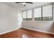 Sunroom with three windows, hardwood floors and a ceiling fan at 122 Maison Nw Pl, Atlanta, GA 30327