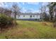 Wide angle view of backyard showcasing the home's exterior and landscaping at 1496 S Hairston Rd, Stone Mountain, GA 30088