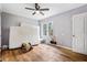 Bedroom with hardwood floors, ceiling fan, and a window overlooking the backyard at 1496 S Hairston Rd, Stone Mountain, GA 30088