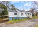 Charming single-story home featuring a driveway, front porch, and light-colored siding at 1496 S Hairston Rd, Stone Mountain, GA 30088