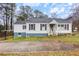 Charming single-story home featuring a driveway, front porch, and light-colored siding at 1496 S Hairston Rd, Stone Mountain, GA 30088