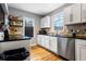 Bright kitchen featuring stainless steel appliances, white cabinetry, and granite countertops at 1496 S Hairston Rd, Stone Mountain, GA 30088