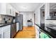 Well-lit kitchen with stainless steel appliances, granite countertops, and hardwood floors at 1496 S Hairston Rd, Stone Mountain, GA 30088