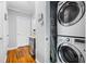 Laundry room with stacked washer and dryer, and wood-look flooring at 1496 S Hairston Rd, Stone Mountain, GA 30088