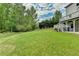 Lush green backyard with mature trees and a tiered deck off the house at 2455 Kirkstone Dr, Buford, GA 30519