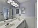 Bathroom featuring double sink vanity, decorative lighting and wainscoting at 2455 Kirkstone Dr, Buford, GA 30519