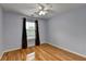 Bedroom with hardwood floors, ceiling fan, and window with blinds at 2455 Kirkstone Dr, Buford, GA 30519