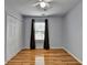 Cozy bedroom features hardwood floors, a ceiling fan, and a closet at 2455 Kirkstone Dr, Buford, GA 30519