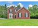 Charming two-story brick home featuring a well-manicured lawn, black shutters and a beautiful bay window at 2455 Kirkstone Dr, Buford, GA 30519