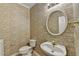 Charming half bathroom with decorative wallpaper, round mirror, and unique sink at 2455 Kirkstone Dr, Buford, GA 30519