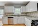 Well-equipped kitchen featuring stainless steel appliances, granite countertops, and beautiful wood floors at 2455 Kirkstone Dr, Buford, GA 30519