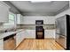 Well-equipped kitchen featuring stainless steel appliances, granite countertops, and beautiful wood floors at 2455 Kirkstone Dr, Buford, GA 30519