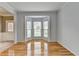 Inviting living room with gleaming hardwood floors and large bay windows offering plenty of natural light at 2455 Kirkstone Dr, Buford, GA 30519