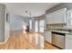 Open floor plan with hardwood floors flowing into a kitchen with granite countertops and stainless steel appliances at 2455 Kirkstone Dr, Buford, GA 30519