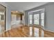 Living room featuring gleaming hardwood floors with a view to the entry way and dining area at 2455 Kirkstone Dr, Buford, GA 30519
