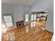 Open concept living room with vaulted ceilings, fireplace, and flows into a bright kitchen at 2455 Kirkstone Dr, Buford, GA 30519