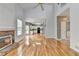 Living room featuring hardwood floors, fireplace, and access to the kitchen at 2455 Kirkstone Dr, Buford, GA 30519