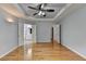 Spacious main bedroom with tray ceiling, ceiling fan, hardwood floors, and abundant natural light at 2455 Kirkstone Dr, Buford, GA 30519