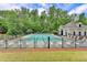 Sparkling pool with plenty of chairs, surrounded by lush greenery and fencing for privacy at 2455 Kirkstone Dr, Buford, GA 30519
